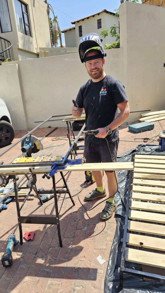 Handyman welding a gate